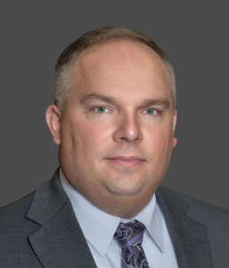 Tom Prunier professional headshot in suit and tie
